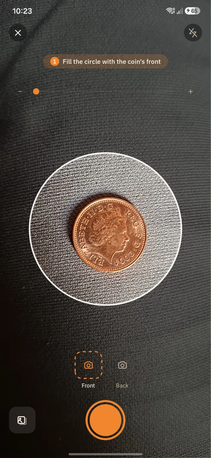 CoinLens camera guiding the user to fill the circle with the front of a coin